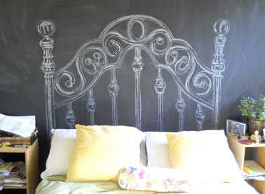 Une tête de lit dessinée à la craie sur le mur facile à fabriquer pour qui a un bon coup de crayon. Toute la surface du mur est peinte avec une peinture à tableau noir. Pour donner l'effet tableau d'école essuyé, frottez à la craie blanche  l'ensemble du mur. La tête de lit est ensuite dessinée à la craie.