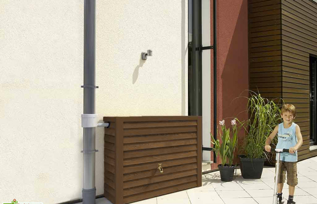 récupérateur d'eau de pluie habiller de lames en chêne couleur foncée assorti aux volets et porte bois 