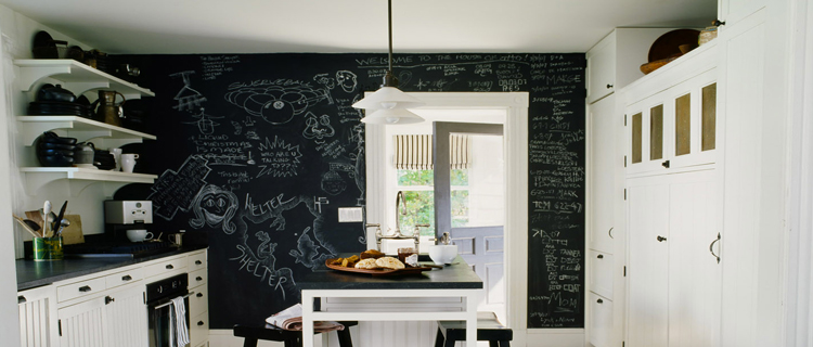 Idées déco cuisine avec une peinture tableau noir pour repeindre le mur de la crédence, la porte et relooker la pièce avec des dessins, des messages écrits à la craie blanche.