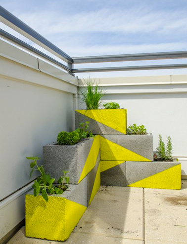 Jeu graphique avec la peinture pour décorer des jardinières en parpaings. Du jaune, gris et vert c'est sympa sur une terrasse en ville !