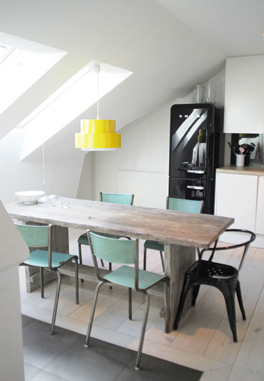 Un ajat-jour jaune vif pour boster la déco d'une cuisine blanche sous combles avec des chaises vert d'eau