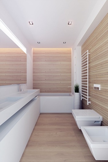 Le trio gagnant de salle de bain en longueur ? Un revêtement bois très clair sur les murs et le sol, un équipement sanitaire design blanc et le miroir sur une des longueurs qui augmente l’impression d’espace.