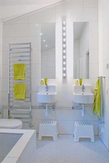 Dans leur salle de bain, les enfants aiment aussi retrouver une déco épurée comme celle de leur parents. Du carrelage et des vasques blanches, des miroirs et un porte-serviette échelle en inox avec des serviettes jaunes pour la touche de couleur.