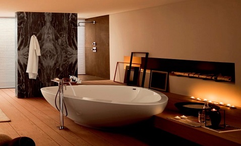 Dans une salle de bain zen, une baignoire ovale apporte un cachet design à la pièce.