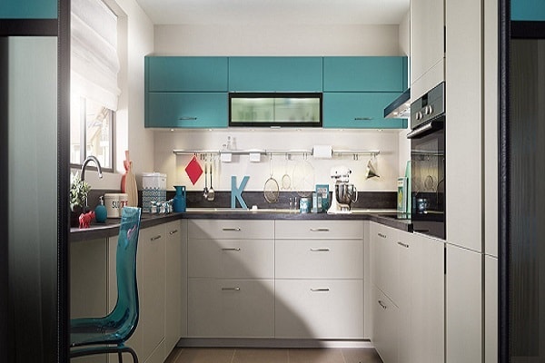 Disposée en U, cette cuisine blanche au plan de travail gris arbore un joli meuble linéaire bleu.