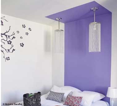 Une façon originale de faire une tête de lit avec une peinture sur le mur se prolongeant sur le plafond blanc