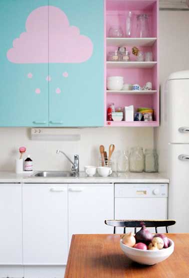 Des motifs peints sur un meuble de cuisine personnalise la déco de cette pièce en un instant. Ici bleu turquoise et rose poudre subliment la cuisine blanche