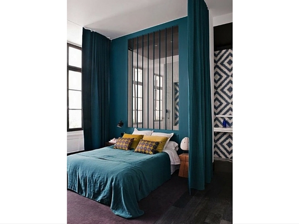 La verrière contribue à mieux définir l’espace à l’intérieur de cette chambre. Les rideaux et le papier peint que l’on peut observer par transparence jouent sur les effets d’optique. 