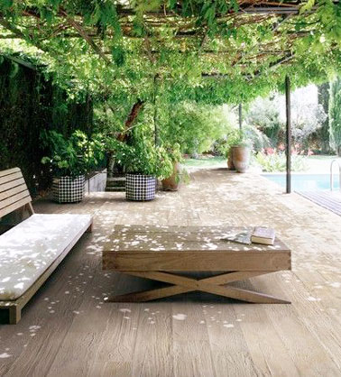 Une terrasse où la déco est assurée par le toit de verdure permettant de se mettre à l'abris du soleil. Un aménagement au bord de la piscine qui donne envie de lézarder 