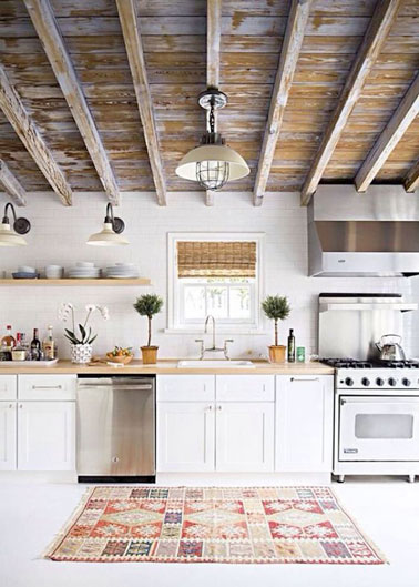Pour une déco élégante et lumineuse dans la cuisine, le blanc s'associe à des couleurs naturelles. Une cuisine blanche pleine de charme décorée d'un joli tapis 