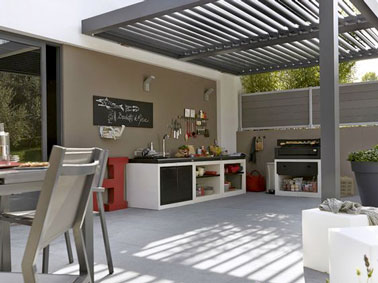 Aménager une cuisine d'été sur la terrasse, une bonne idée quand on a de la place ! Sous la pergola, un côté cuisine et une table de jardin pour manger dehors c'est top