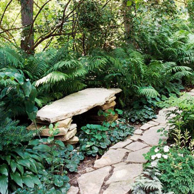 Réalisé au bord de l'allée de jardin, ce petit banc réalisé avec des pierres plates offre un lieu clame et paisible au milieu des plantes pour un moment dans la nature 